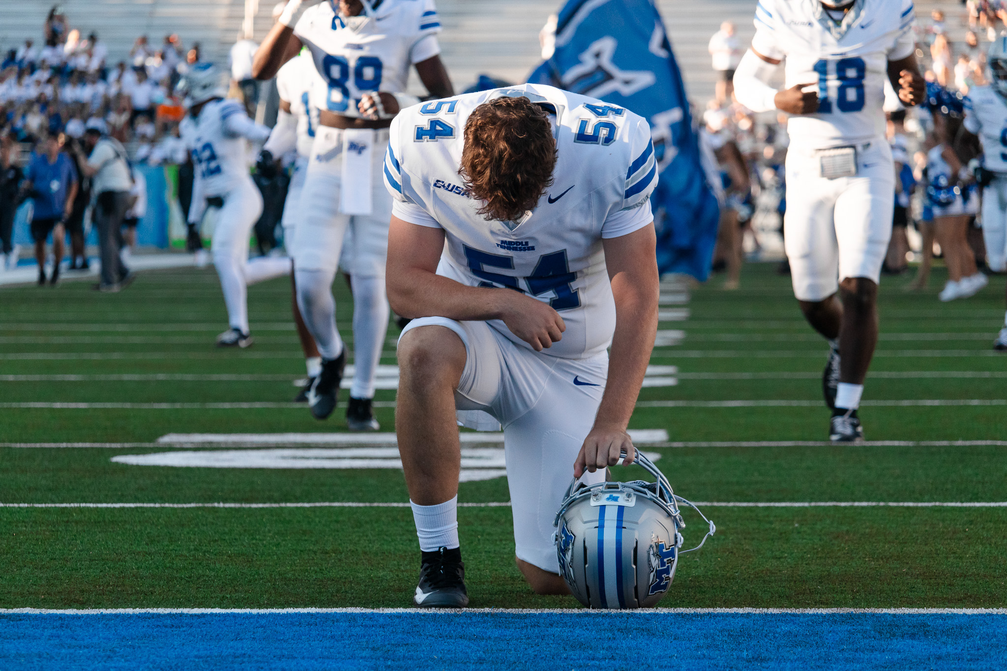 Connor kneeling in prayer